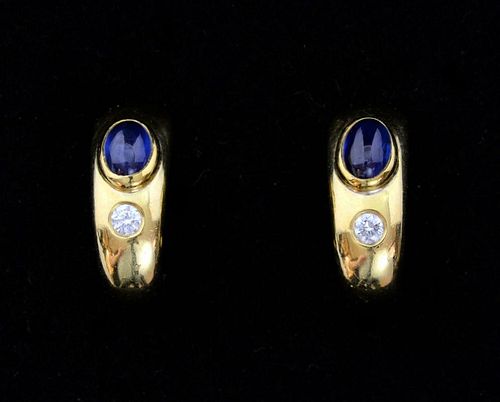 Sapphire and diamond half hoop gold earrings, set with a cabochon cut sapphire and round brilliant cut diamond.