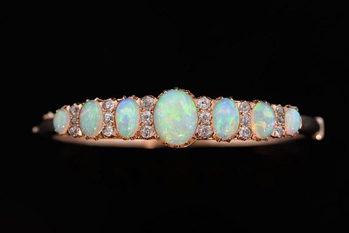 Opal and diamond hinged bangle, set with seven cabochon cut opals spaced by old-cut diamonds mounted in 14ct gold.
