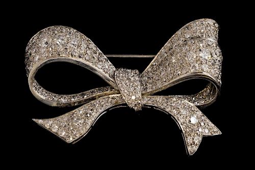 Mid 20th C diamond set bow brooch, the stylised bow set with round brilliant cut diamonds in a white metal. Estimated total d