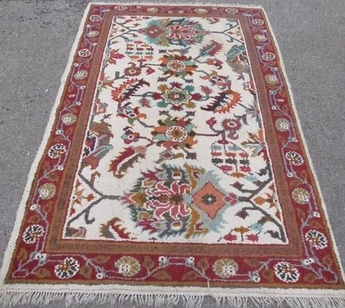 Cream ground rug the centre with styalised foliate forms 240cm x 160cm