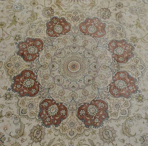 Persian silk carpet with main red border, centre with flower shaped medallion, all over decoration with floral motifs and bir