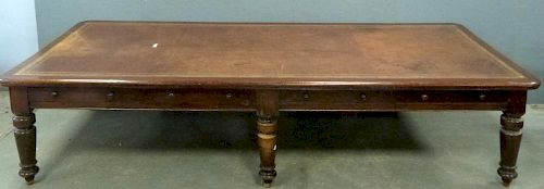 19th century mahogany double partners desk with four drawers to each side on turned legs and casters . 360cm x 128cm.