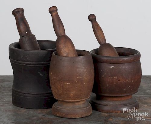 Three turned wood mortar and pestles, 18th/19th c., approximately 11 1/2'' h.