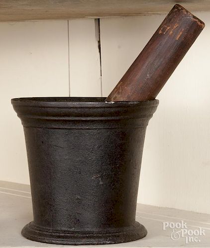 Cast iron mortar, stamped Savery & Co. No. 5, 5 3/4'' h., together with a pine andiron