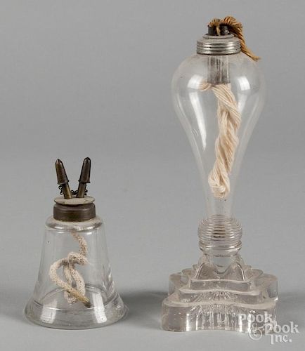 Two colorless glass fluid lamps, 5 1/4'' h. and 10'' h.