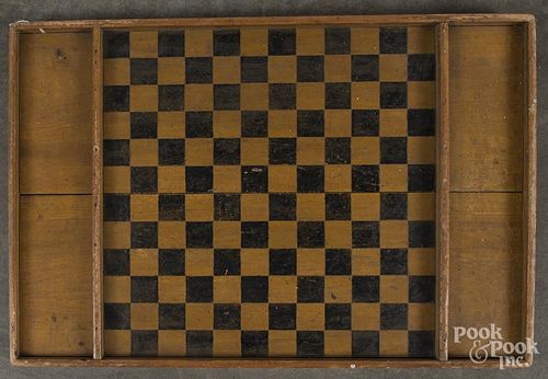Painted pine gameboard, 19th c., retaining its original yellow and black surface, 19 1/2'' x 29''.