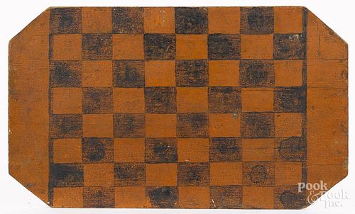 Painted pine gameboard, 19th c., retaining its original orange and black surface, 12 3/4'' x 21 1/2''.