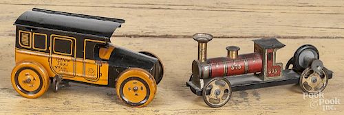 Chein tin wind-up Yellow Taxi, 6'' l., together with a German tin litho flywheel train, 6'' l.