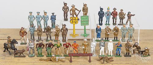 Cast iron and aluminum soldiers and cowboy and Indian play figures, together with three road signs.