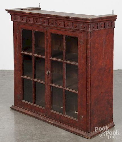 Painted pine hanging cupboard, early 19th c., retaining an old red grained surface, 35'' h., 35'' w.