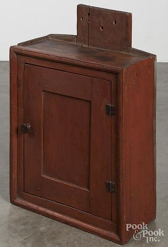 Stained pine hanging cupboard, 19th c., retaining an old red stain, 30'' h., 19 1/2'' w.