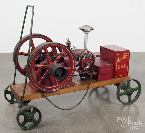 Associated Busy Boy 1 1/2 HP hit and miss engine, ca. 1900, with cast iron wheeled base, 42'' l.