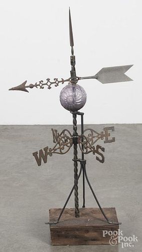 Cast iron weathervane rod with an amethyst lightning ball and directional arrow, mounted on a stand