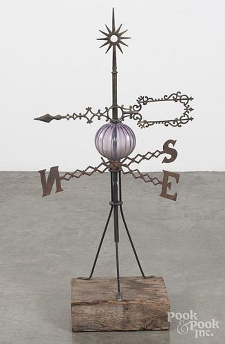 Cast iron weathervane rod with an amethyst lightning ball and directional arrow, mounted on a stand