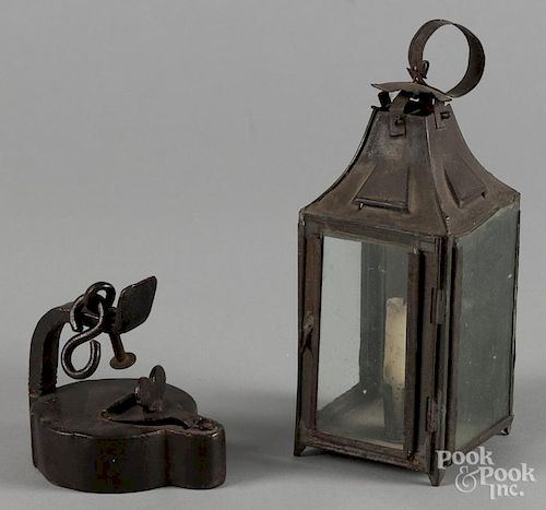 Small tin carry lantern, 19th c., 8'' h., together with an iron fat lamp, 3 3/4'' h.