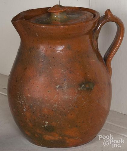 Redware pitcher with a lid, possibly Jugtown, 7 3/4'' h.