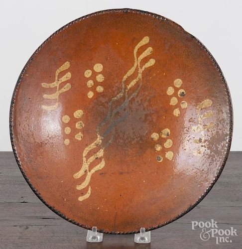 Pennsylvania redware plate, 19th c., with yellow slip decoration, 10 1/2'' dia.