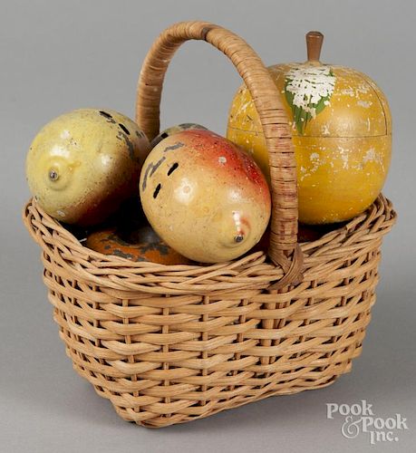 Basket of painted tin fruit, 20th c., together with a turned wooden apple canister