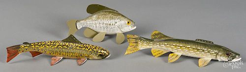 Three Carl Christenson carved and painted fish decoys, to include a trout, a pike, and a bass