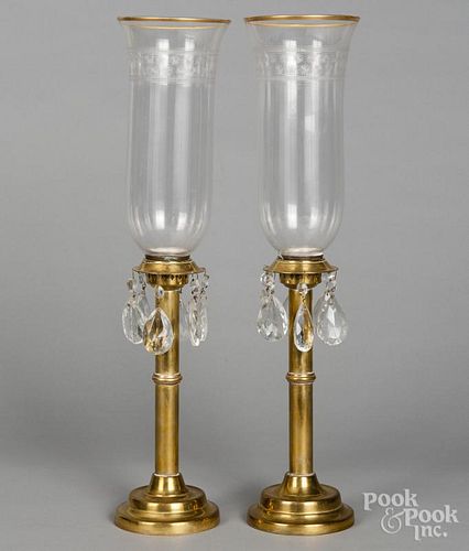 Pair of brass hurricane candlesticks, 19th c., with prisms and etched glass shades, 21'' h.