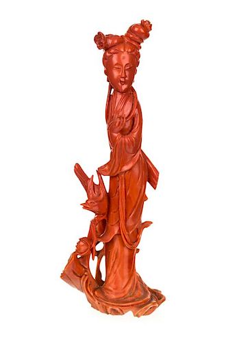 A CHINESE CARVED RED CORAL FIGURE OF A GUANYIN