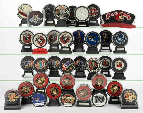 ASSORTED VINTAGE AND CONTEMPORARY AUTOGRAPHED HOCKEY PUCK COLLECTION, LOT OF 34