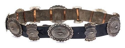 * A Sterling Silver, Copper and Leather Concho Belt, Navajo, 379.20 dwts. (including leather)