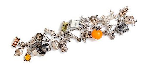 A Vintage Sterling Silver Charm Bracelet with Numerous Attached Charms, 55.60 dwts.