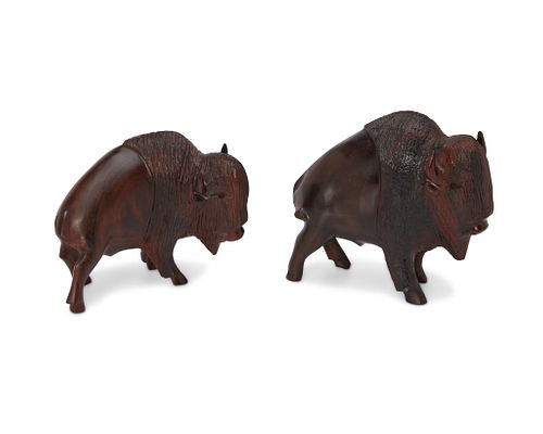 Two ironwood carved bison figures