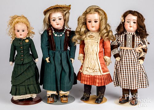 Four bisque head dolls
