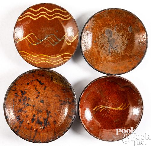 Four redware plates, 19th c.