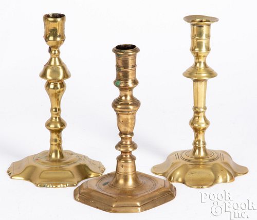 Three Queen Anne brass candlesticks, 18th c.