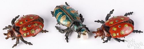 Three tin lithograph beetle penny toys