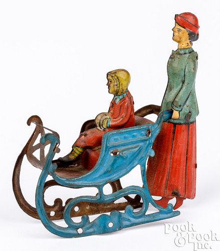 Meier tin lithograph woman pushing sled penny toy