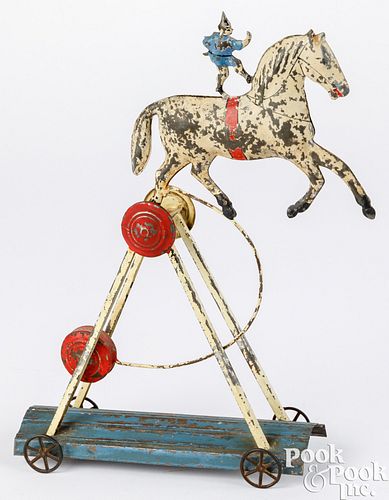 Scarce painted tin horse and acrobat pull toy