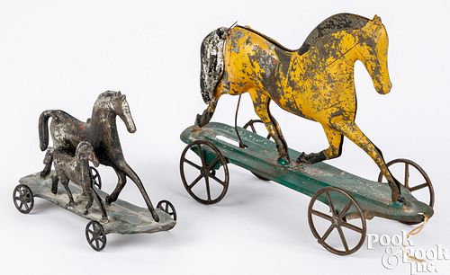 Two early American tin horse pull toys