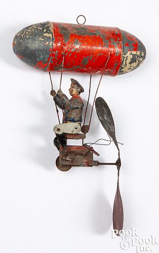 Painted tin wind-up man with zeppelin