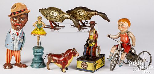 Seven tin lithograph wind-up toys