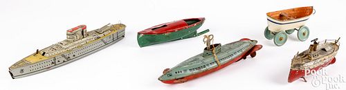Five tin toy boats