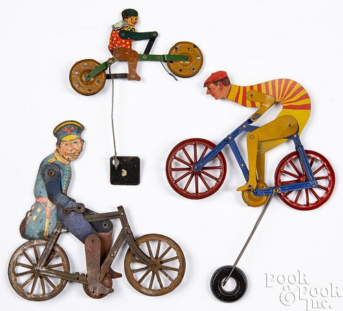 Three tin lithograph bicycle balance toys