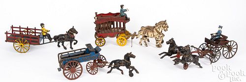 Four cast iron horse drawn wagons