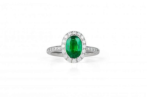 A Kwiat Platinum, Diamond and Emerald Ring
