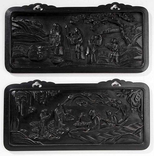 Pair of Ebonized Carved Plaques