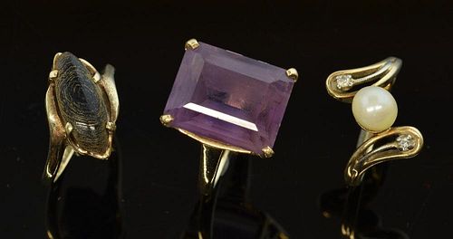 Three gem set gold rings, pearl with small diamonds, a step cut amethyst and a black stone ring, all 14 ct gold
