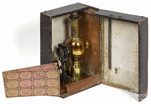 German magic lantern, ca. 1900, with its original case with lens, directions, tickets for admission