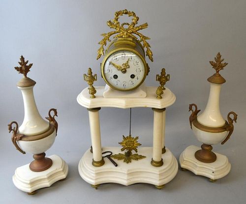 White marble and gilt metal clock garniture with white porcelain dial and Arabic numerals.