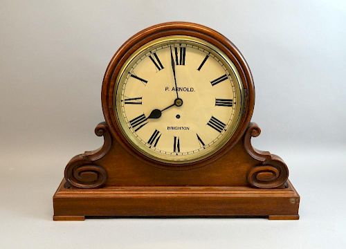 Late 19th Century mahogany mantle clock with black Roman numerals, marked for P. Arnold of Brighton on a rectangular base. 43