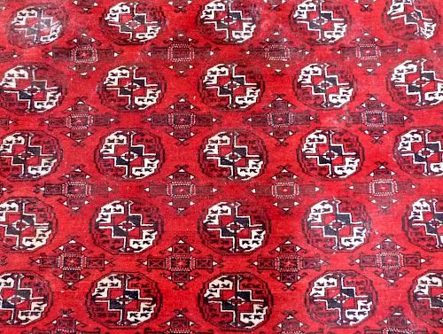 Afghan type red ground  carpet the centre with repeating medallions 370cm x 320cm