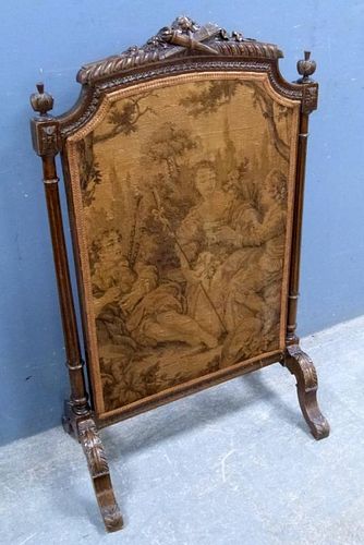 Victorian fire screen with tapestry panel, the cresting rair carved with a torch and quiver. 100 cm high, 60 cm wide