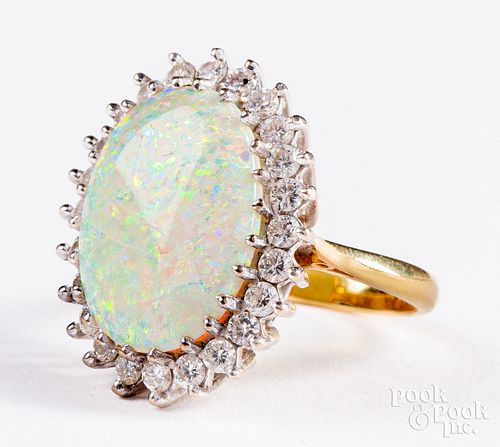 18K gold halo ring with oval opal cabochon